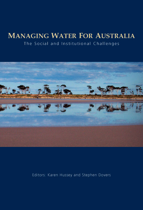 The cover image of Managing Water for Australia, featuring a panoramic view of sparse trees in red land reflected in flat water.