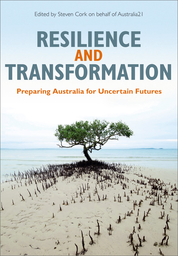 The cover image of Resilience and Transformation, featuring a tree on a sandy piece of land with blue water in the background.