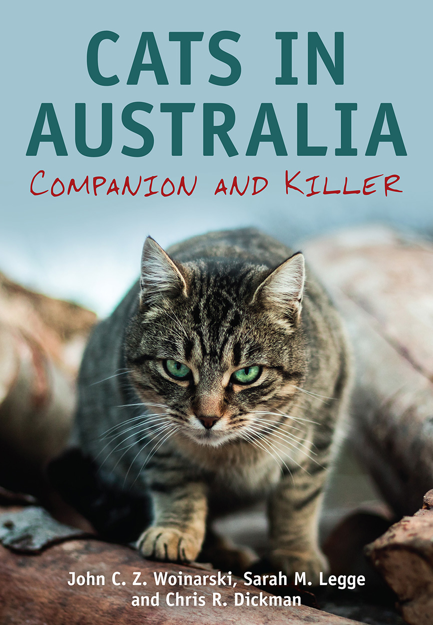 Cover of Cats in Australia featuring a crouching green-eyed cat glaring directly at the viewer