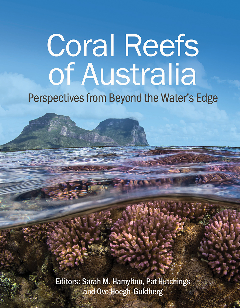 Cover of 'Coral Reefs of Australia', featuring a photo of a coral reef underwater with an island above the water in the background.