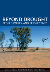 The cover image of Beyond Drought, featuring brown red land with four small trees and a wind mill in the background.