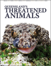 The cover image of Queensland's Threatened Animals, featuring a lizard on a mossy rock looking face on with its tounge licking its snout.
