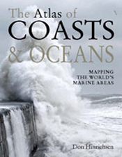 Cover features white foam waves crashing onto a cliff face, with a grey sk