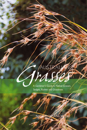 Cover features close up dry brown grass against blurry green background.