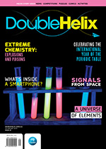 Magazine cover with set of glowing test tubes on black background.