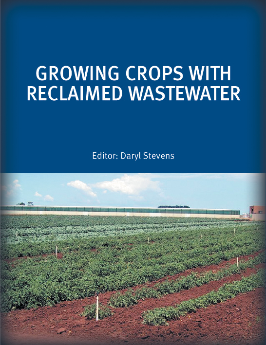 The cover image of Growing Crops with Reclaimed Wastewater, featuring a view of small green lines of growing produce with red dirt and blue skies.