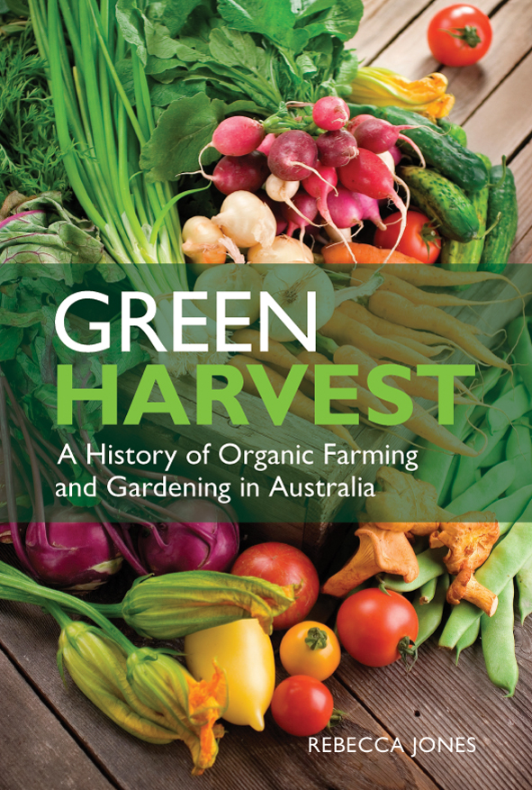 The cover image of Green Harvest, featuring various brightly coloured vegetables on a slated wooden surface.