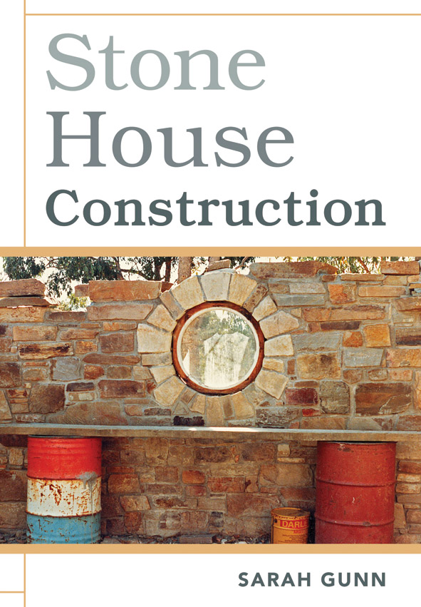 The cover image of Stone House Construction, featuring a stone wall with a circular featuring in the middle, with teo brightly coloured barrels sittin