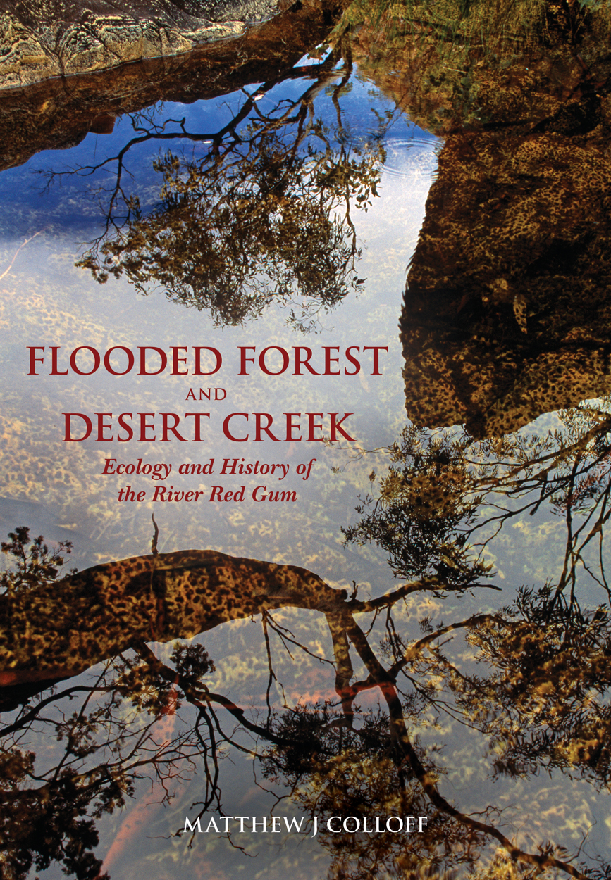Cover image is a reflection of large trees in a water surface.
