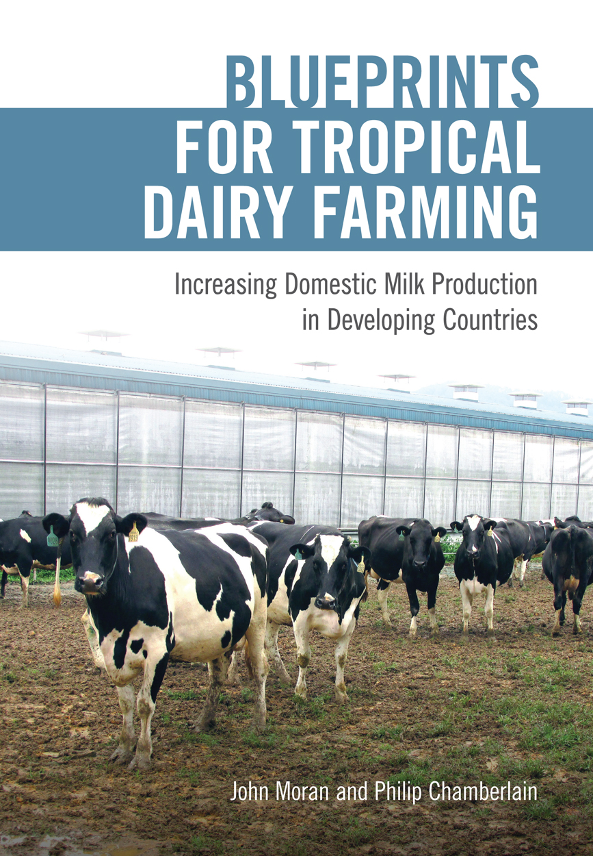 Cover featuring several dairy cows standing in front of a milking shed.