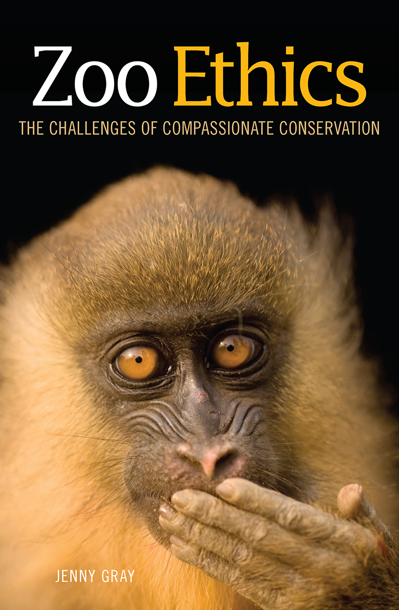 Cover featuring a portrait of a mandrill, with its hand over its mouth and eyes gazing directly at the viewer.