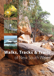 The cover image features one large photo of a woman walking over large red boulders; in the top left hand of the cover three smaller images.