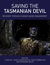 Cover of Saving the Tasmanian Devil featuring a photo of a Tasmanian devil standing on a tree stump at night.