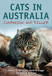 Cover of Cats in Australia featuring a crouching green-eyed cat glaring directly at the viewer