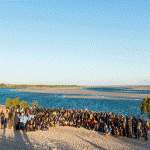 Photograph of attendees of the 2019 Northern Australia Indigenous Biosecurity Ranger Forum, standing on a beach.